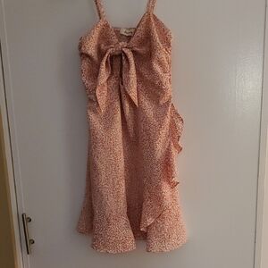 Elegant Pink Floral Dress With Ruffle And Peek A Boo Hole.